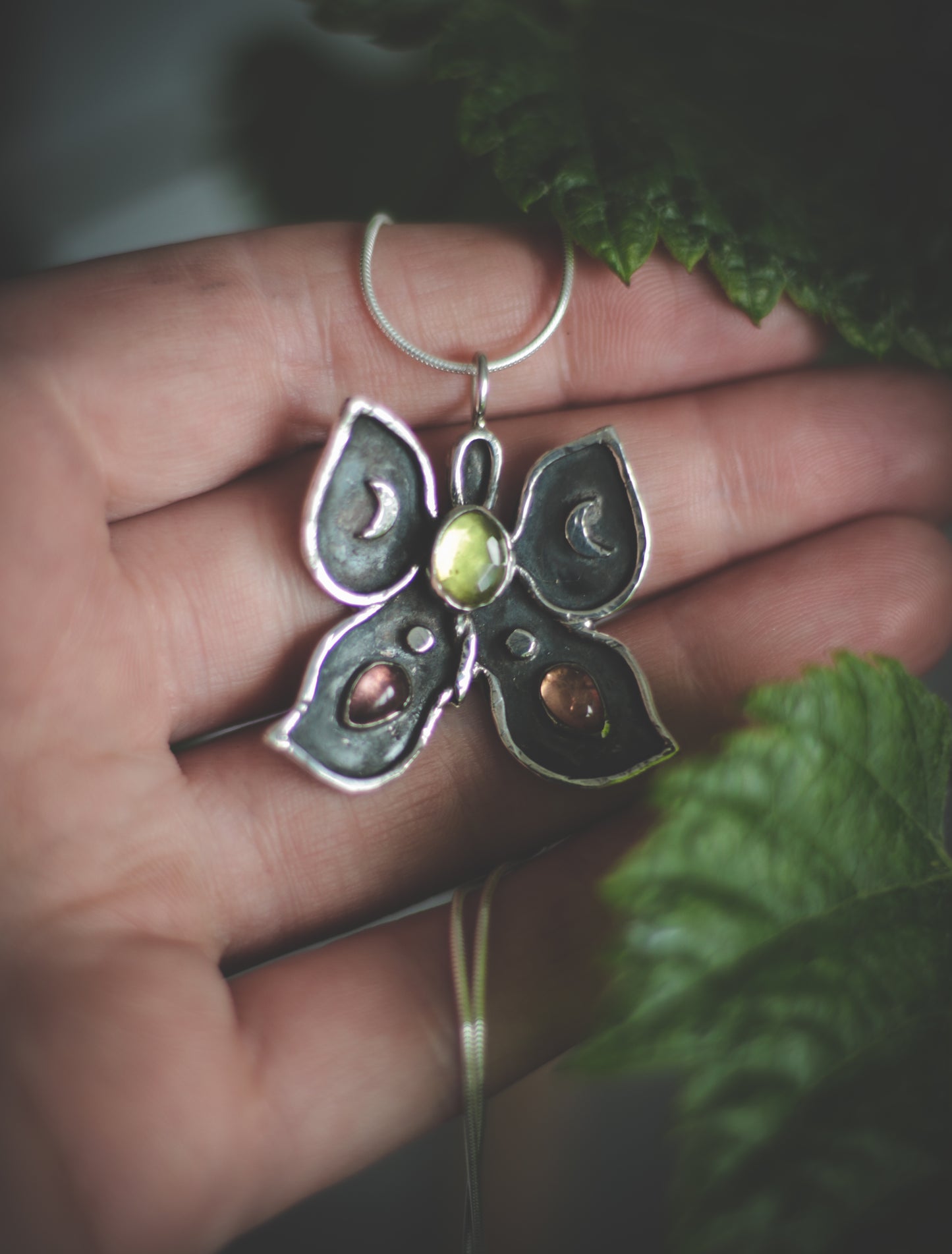 Butterfly necklace with Peridot and Tourmaline.