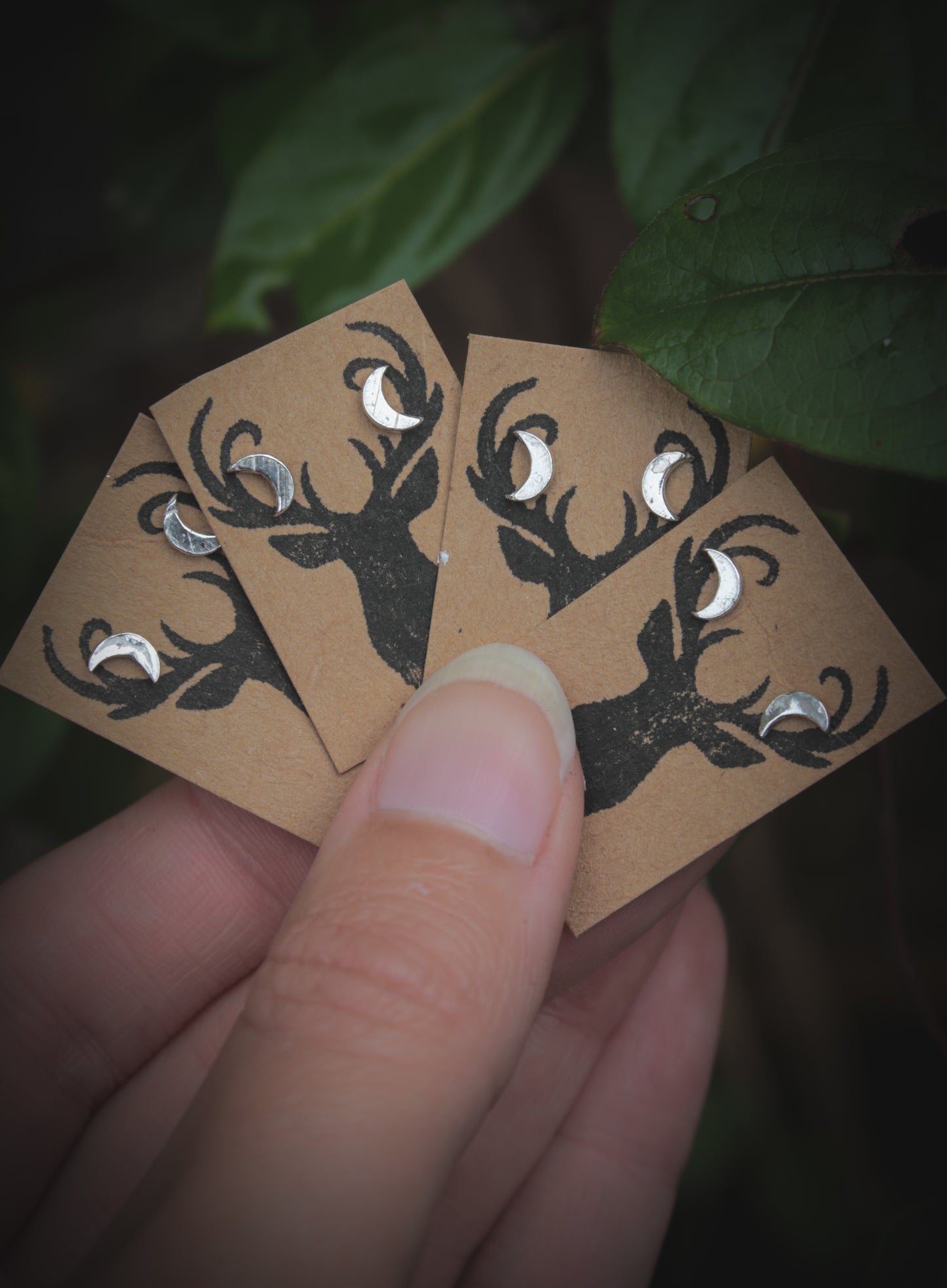 Silver crescent moon studs.