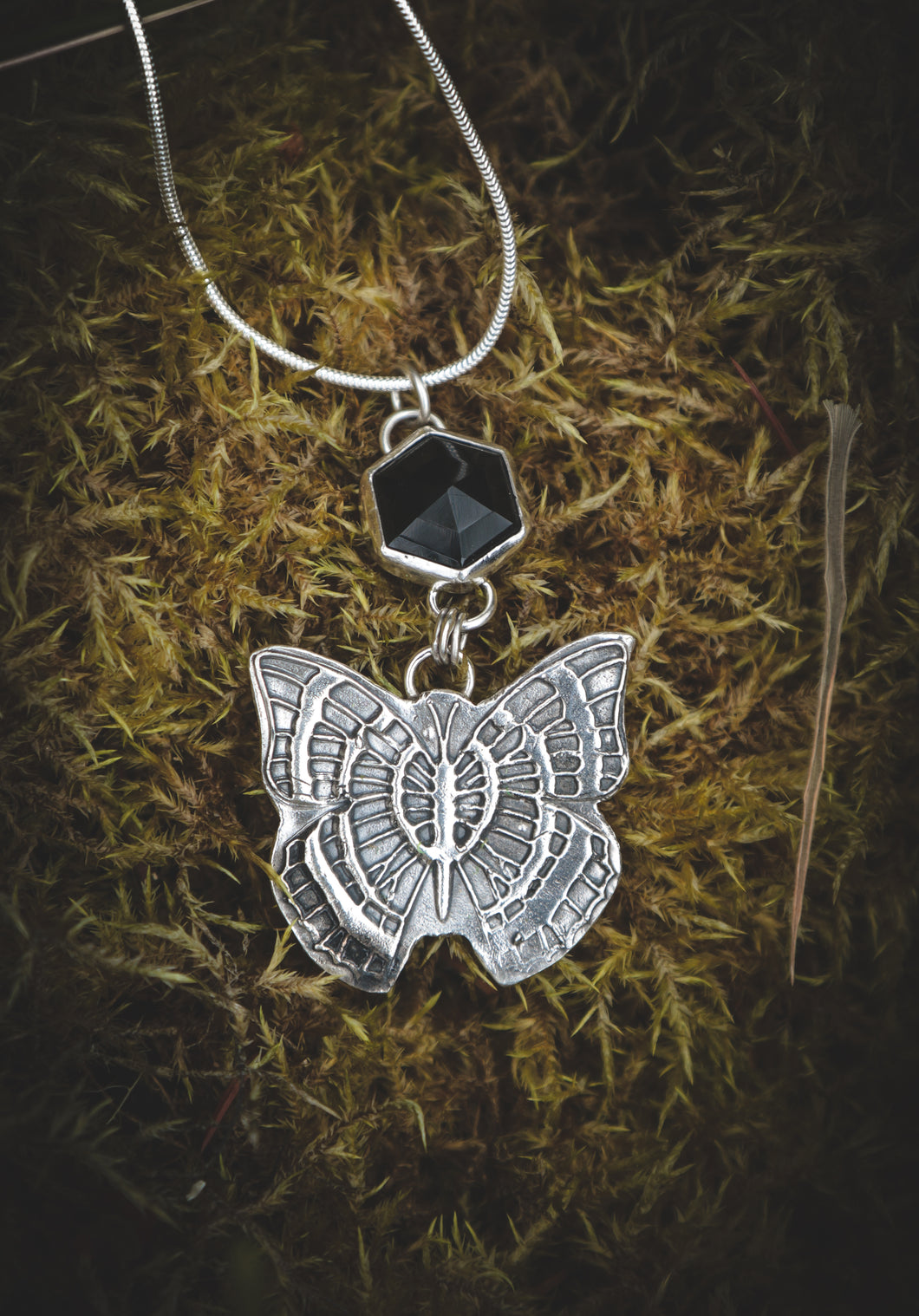 Black Onyx necklace with silver butterfly.