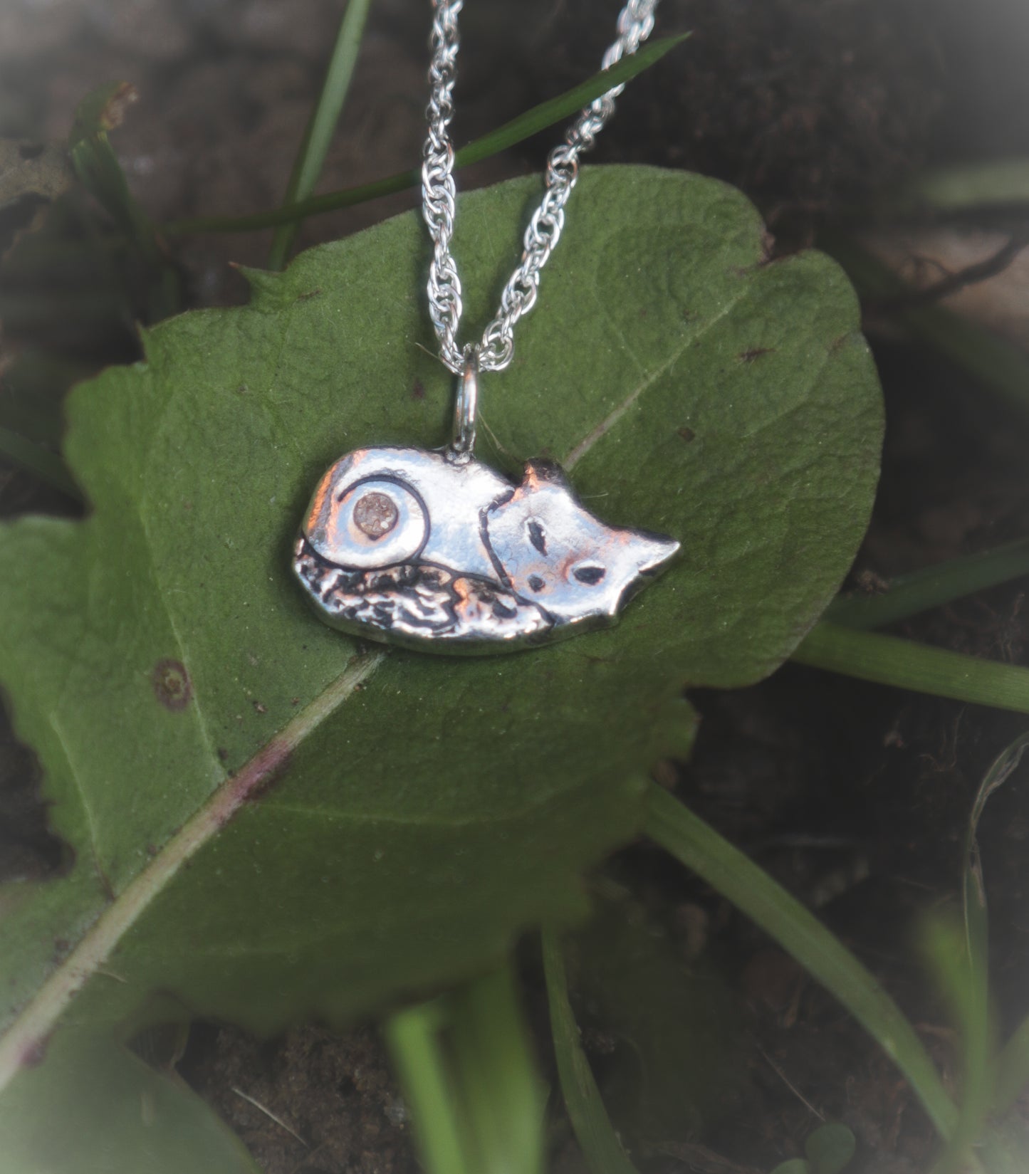 A cute sleeping fox necklace, with Cubic Zirconia
