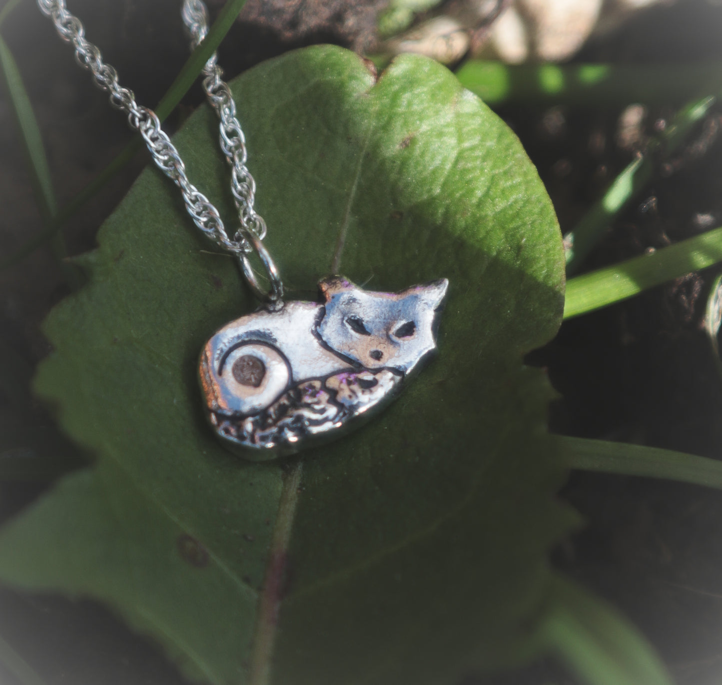 A cute sleeping fox necklace, with Cubic Zirconia